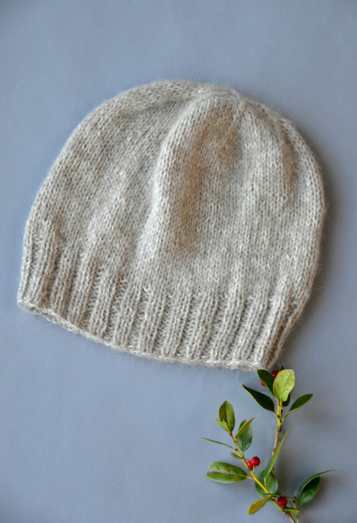 Image of an oatmeal-colored hat on a gray background