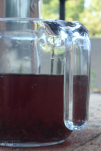 Measuring cup of purplish liquid dye