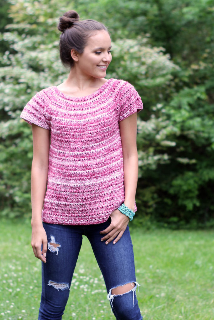 Smiling woman in jeans and crochet red Cotton Supreme DK Seaspray shirt