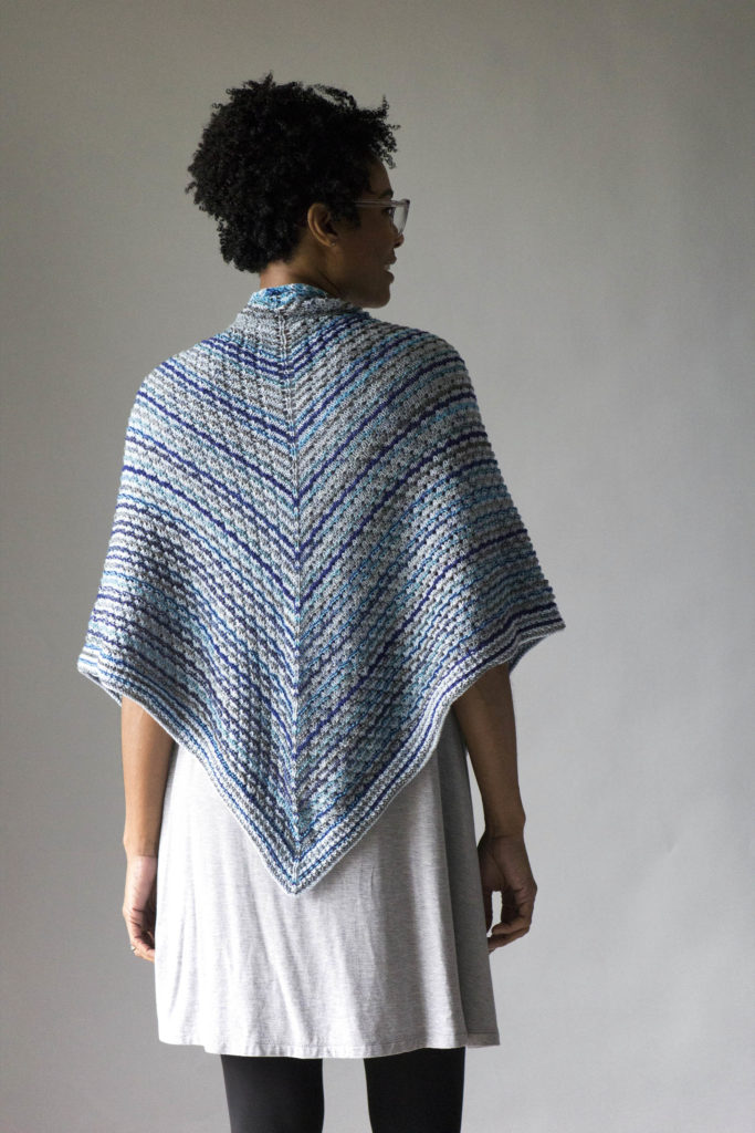 rear view of triangular knitted blue striped shawl