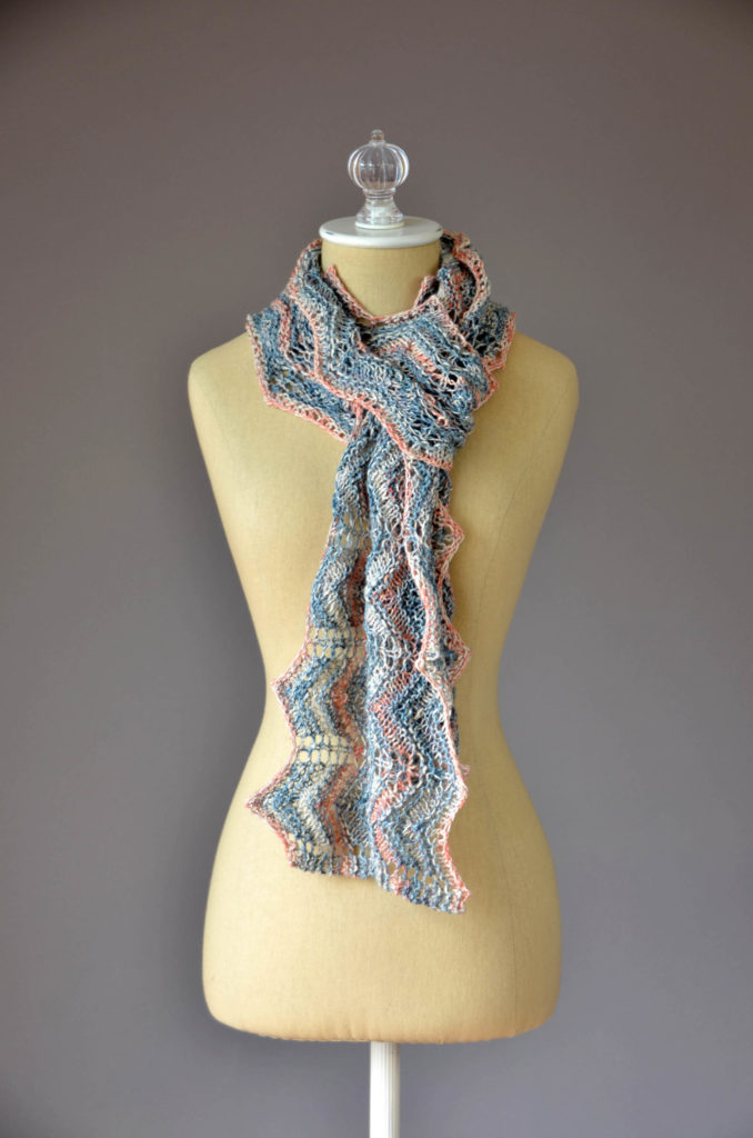 Sideways-knitted scarf modeled on dressform
