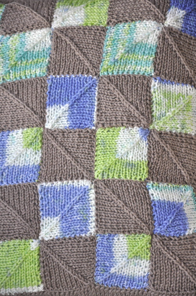 Detail of knit mitered square knitting pattern on pillow