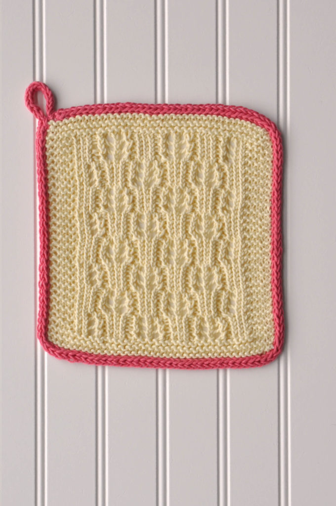 yellow knitted cotton washcloth with loop for hanging