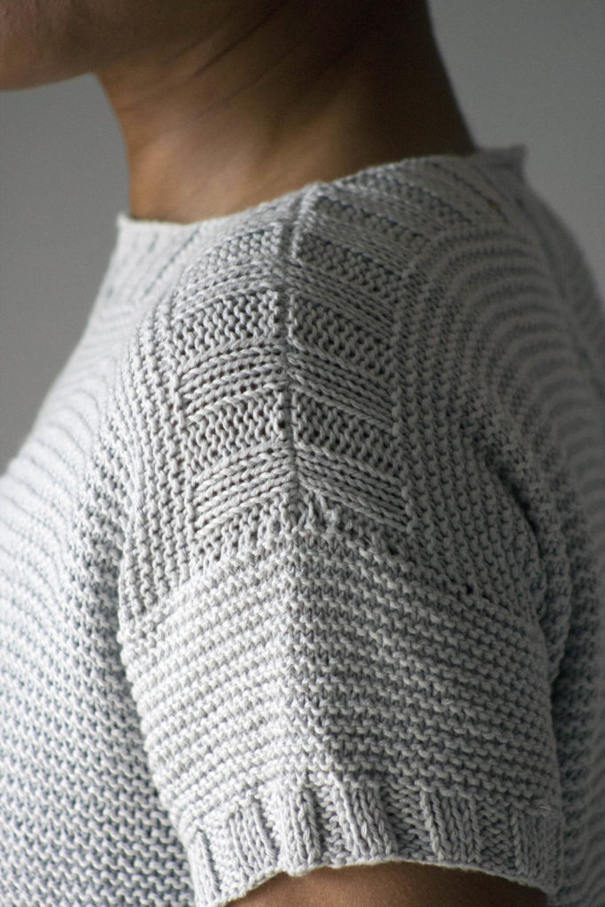 Detail of sleeve on light blue short sleeve knit pullover