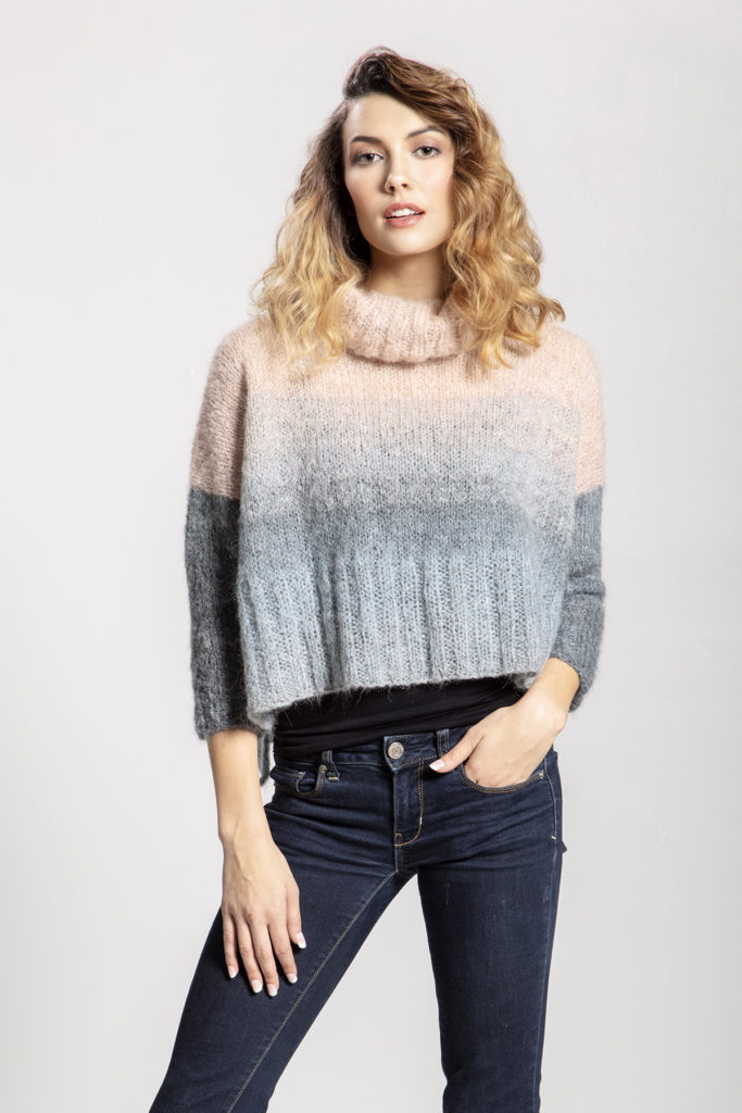 woman wearing pale pink and grey pullover knit in Universal Yarn Revolutions