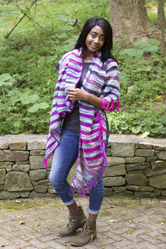 Woman wearing long triangular striped shawl knit in Bamboo Bloom and Poems Sock
