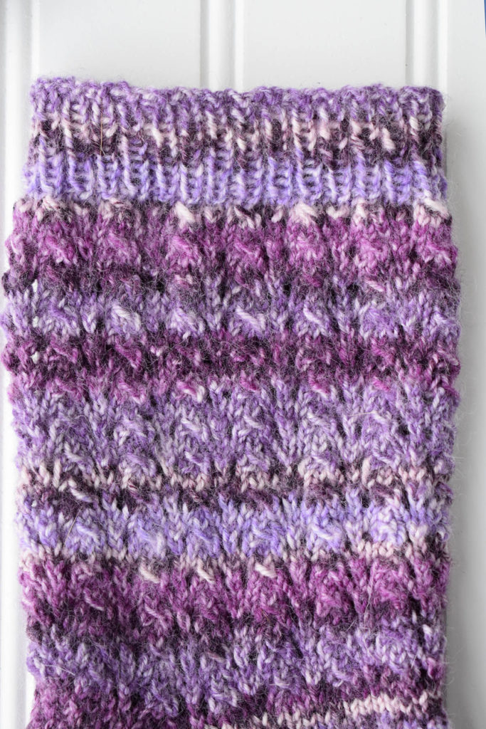 purple sock leg showing lace pattern