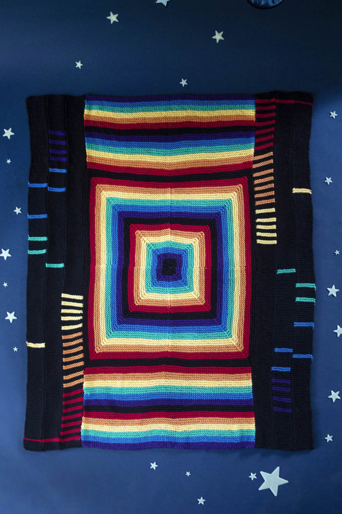 A rainbow-colored blanket knit in Cotton Supreme. 