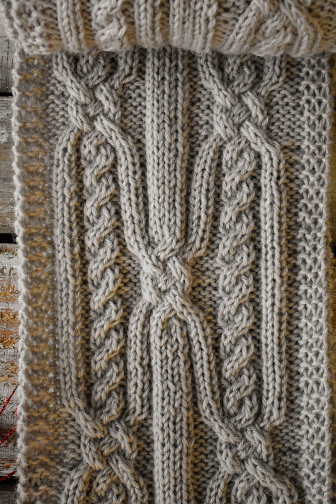 Detail of a cabled scarf knit in Deluxe Worsted.