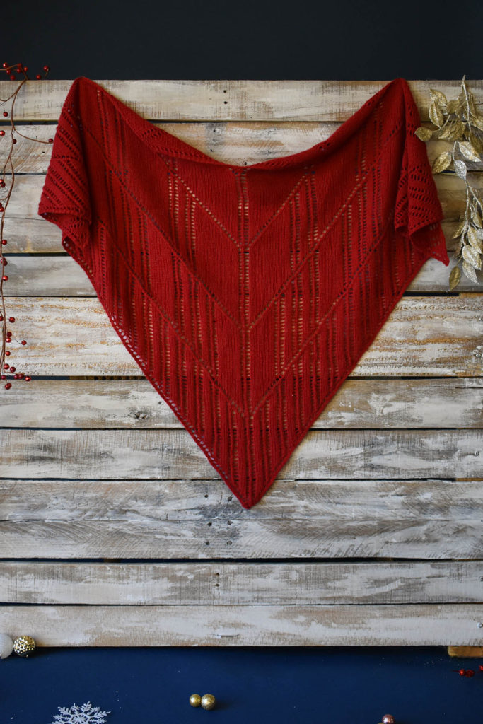 A red, lace shawl knit in Fibra Natura Cashmere Lusso. 