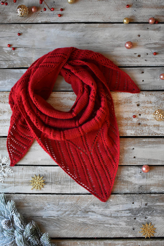 A red, lace shawl knit in Fibra Natura Cashmere Lusso.