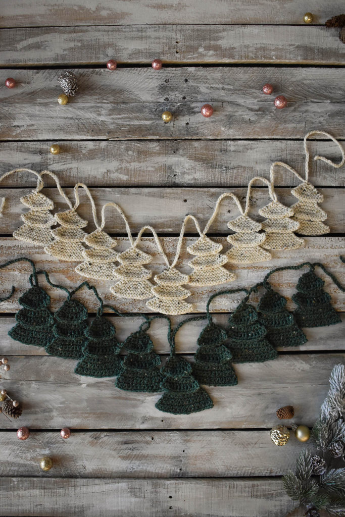 Two garlands featuring pine tree motifs, one knit and one crochet, both created using Universal Yarn Deluxe Worsted Tweed Superwash. 
