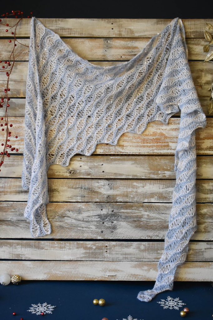 A striped, drop-stitch shawl knit in Rozetti Yarns Cotton Gold and Rozetti Yarns Alaska