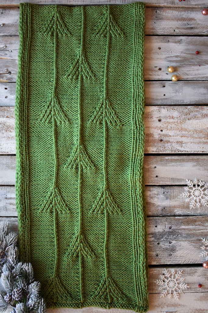 A green, twisted stitch cowl knit in Universal Yarn Deluxe Chunky. 