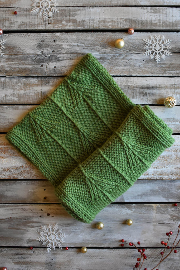 A green, twisted stitch cowl knit in Universal Yarn Deluxe Chunky.