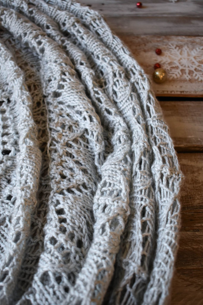 Detail of a lace blanket knit using Universal Yarn Uptown Worsted.