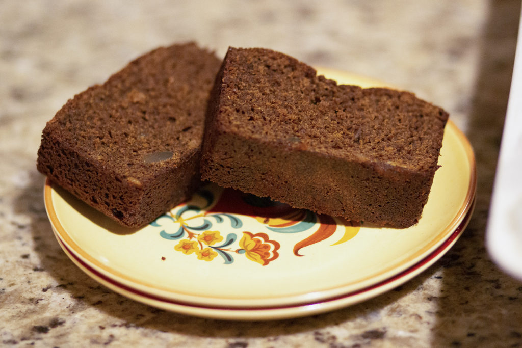 Two slices of gingerbread loaf on a plate.