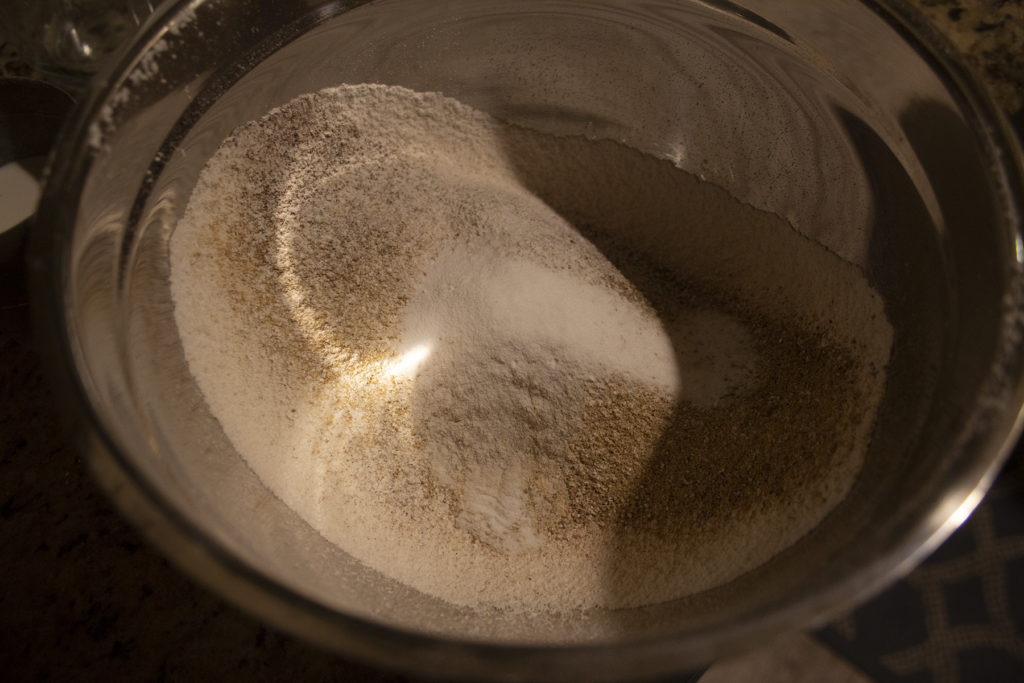 A bowl of flour and spices sifted together.