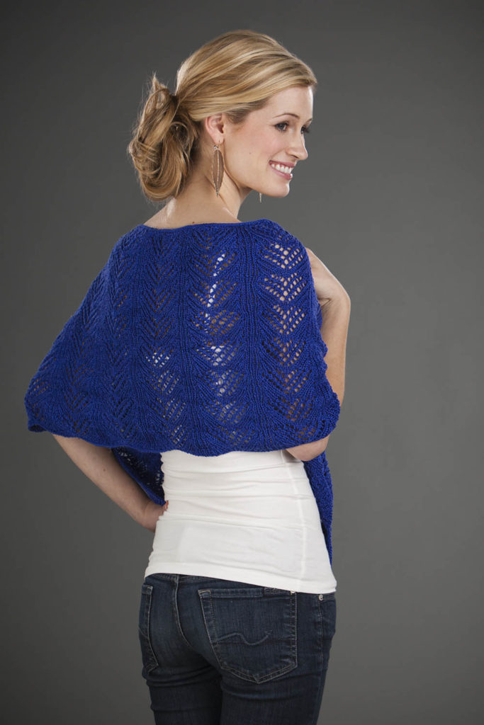 A hand knit lace shawl in blue 