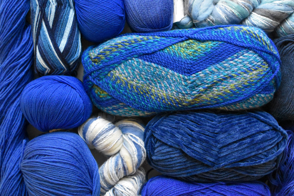 Skeins of blue yarn laid on a table