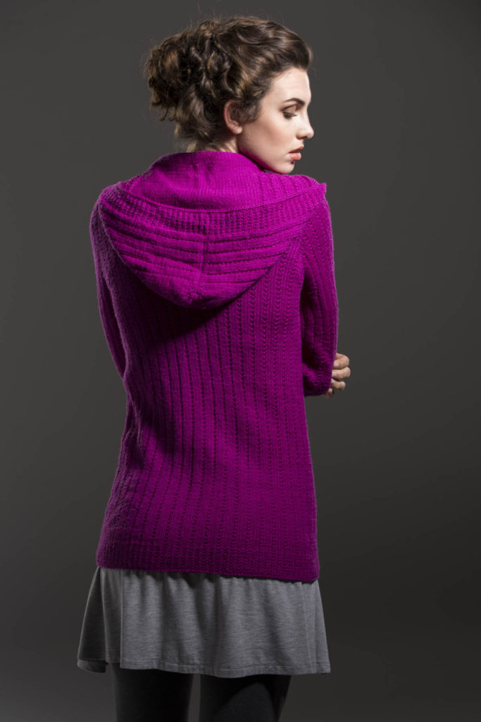 Rear view of woman wearing knit hooded cardigan