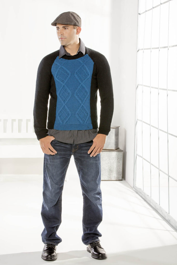Image of man in black and blue cabled sweater knit in Dona yarn