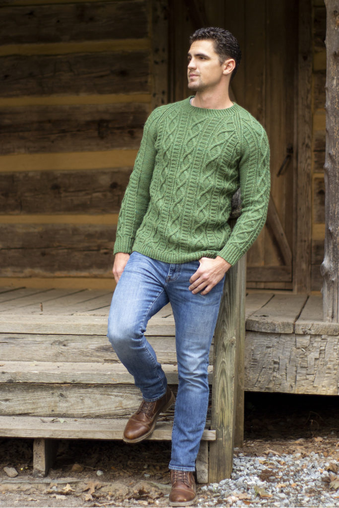 Image of man wearing green cable knit pullover