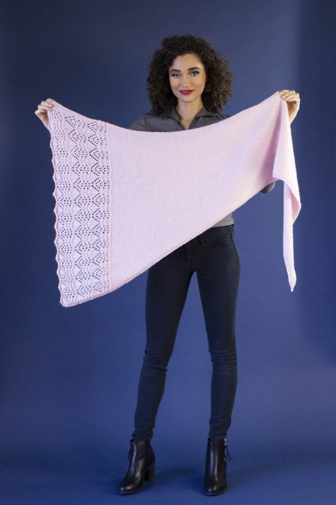 woman holding pink lace shawl knit in Angora Lace yarn
