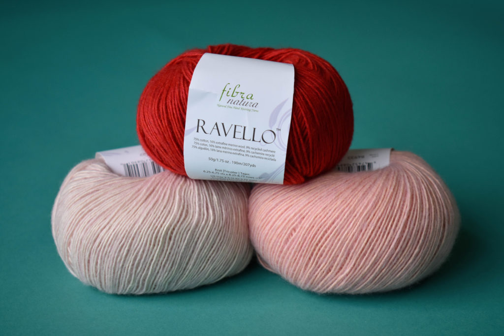 Three balls of Fibra Natura Ravello in shades of pink and red.