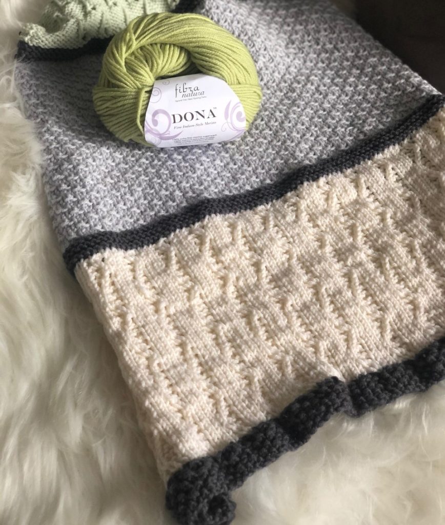 A flat photo of a knit shawl