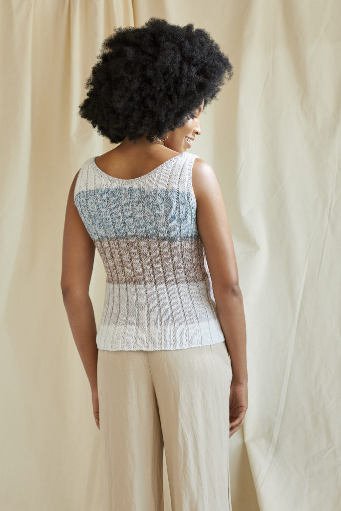 Rear view of woman wearing blue, grey, and taupe tank top