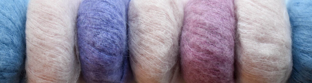 closeup of row of pastel Penna yarn balls