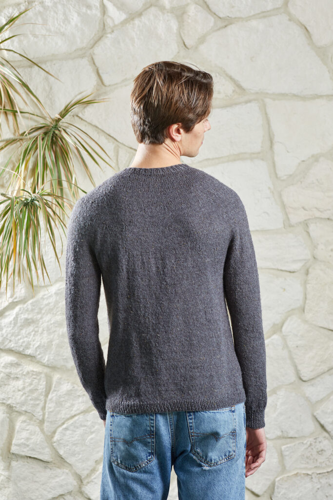 Rear view of young man wearing gray Damascus sweater knit in Kingston Tweed