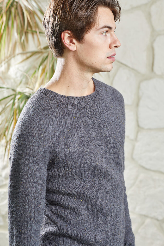 Young man in profile wearing gray Damascus sweater knit in Kingston Tweed
