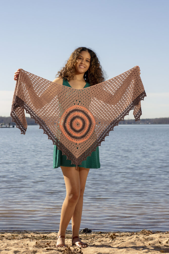 Woman holding crochet shawl