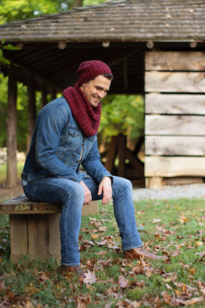 man wearing maroon colored scarf and hat