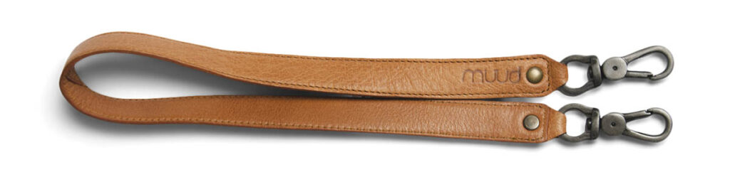 Tan leather purse strap embossed with "muud"