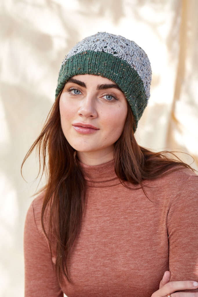 woman wearing green and light blue knitted hat