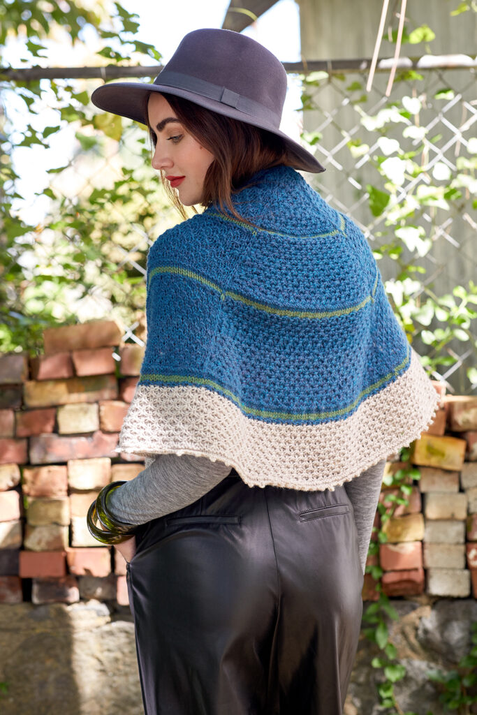 Rear view of woman wearing knitted shawl