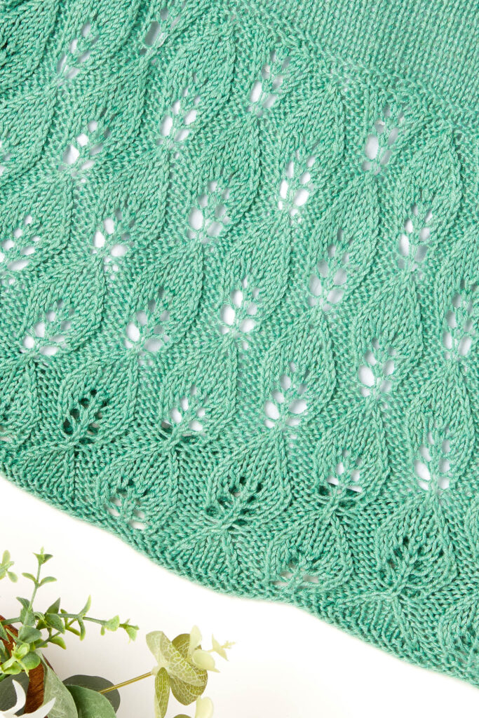 Closeup of knitted leaf lace design
