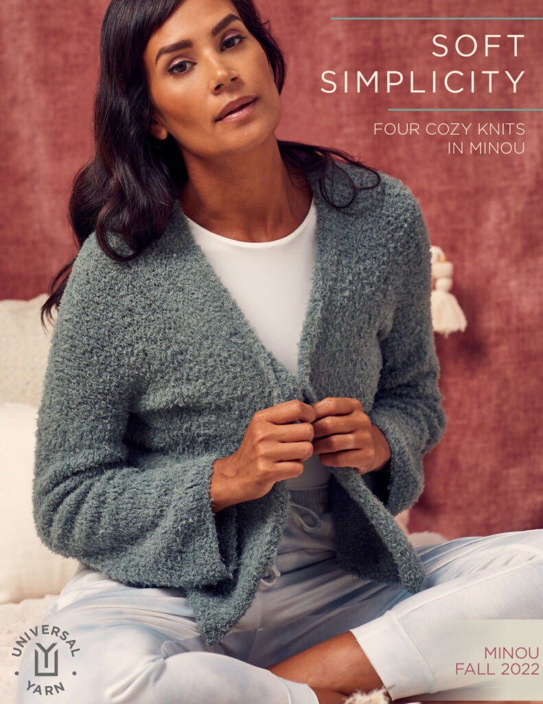 A woman wearing a blue-grey cardigan knit from Universal Yarn Minou. The words "Soft Simplicity" are in the upper right corner. This is the cover of an ebook. 