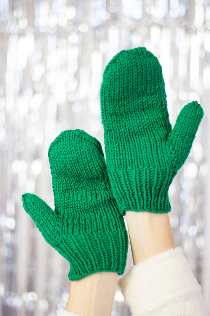 Two hands showing the palm side of the Hemlock Set mittens, showing stockinette stitch and ribbing. 