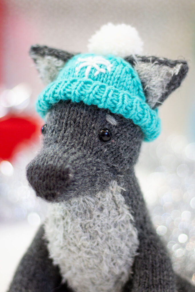 Hubble the Winter Wolf, a hand knitted toy using Universal Yarn Deluxe Worsted and Universal Yarn Minou. 
