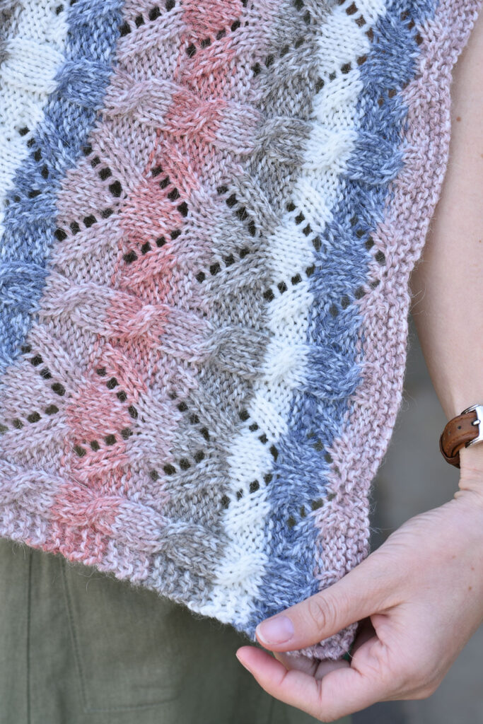 Close up photo of the Snapdragon wrap, with a cable and lace pattern.