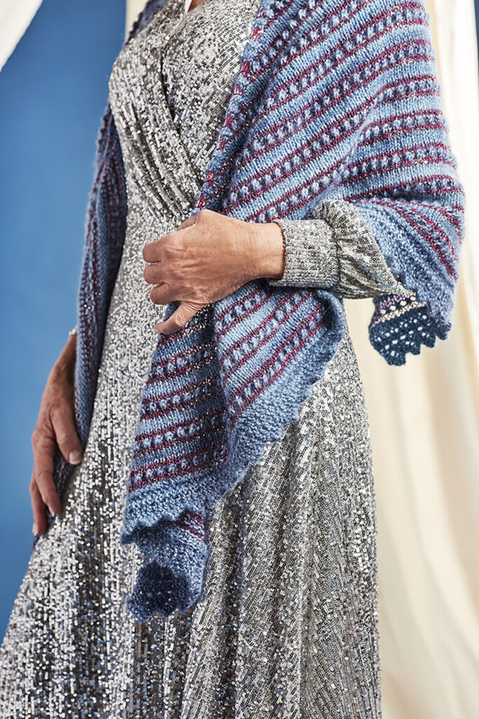 Close-up image of the Ardenne shawl wrapped around person with lace edges shown