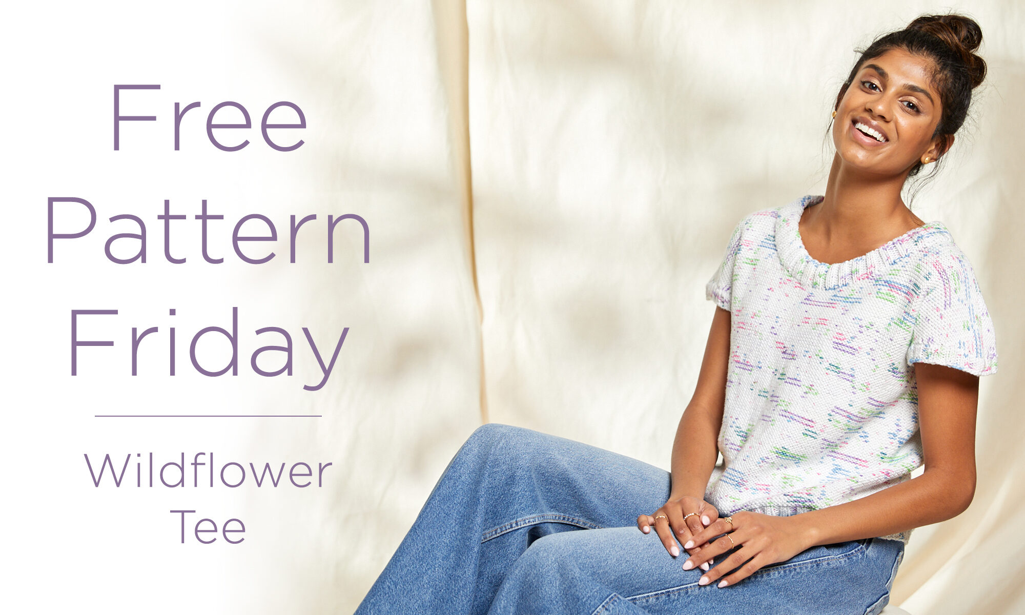 Photo of a person sitting down with the Wildflower Tee on with text to the left saying "Free Pattern Friday - Wildflower Tee"