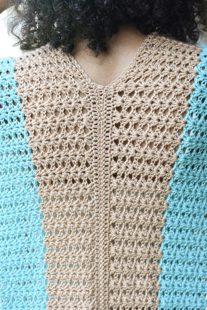 A close-up detail of the back of the crocheted Subtle Shell Ruana, made in Universal Yarn Uptown Bamboo DK. 