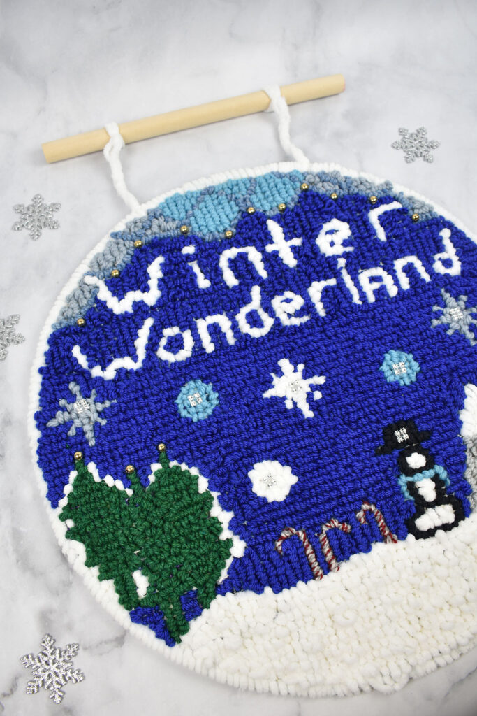 A close up image of the Winter Wonderland Wall Hanging using a variety of yarns from Universal Yarn. 